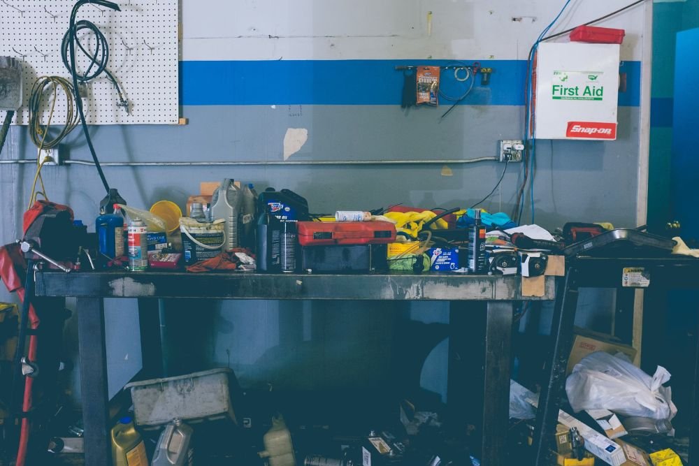 A man seated in a tool-filled garage, highlighting a junk removal service based in Washington, DC.