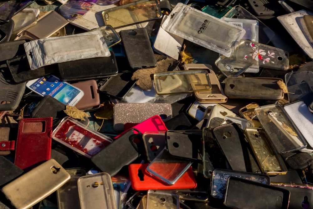 A stack of outdated cell phones symbolizing electronic waste for a Washington, DC junk removal service.
