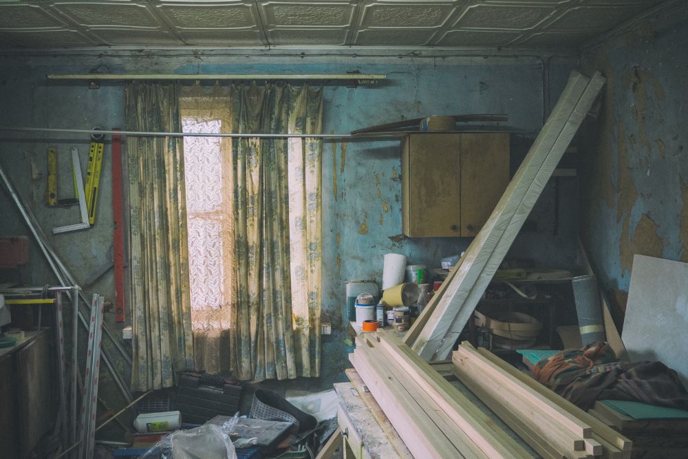 An aged room featuring numerous tools and a window, symbolizing an indoor junk removal service in Washington, DC.