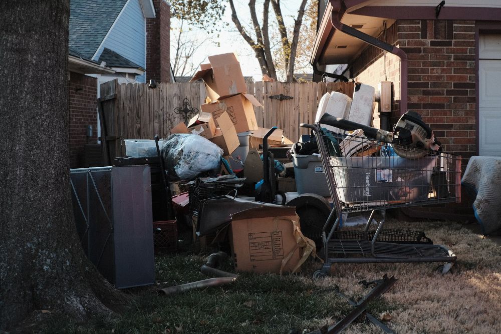 A messy yard overflowing with boxes and junk, highlighting the services of an outdoor junk removal company in Washington, DC.